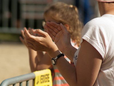 woman spectator clapping from sidelines