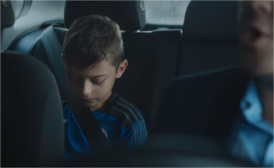 kid in back of car getting lectured by father on performance at practice
